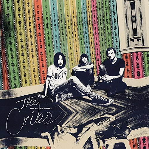 "Album cover with three men sitting on steps, multicolored wallpaper, and 'The Cribs' text."