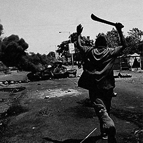 A black and white image of a man wielding a club amidst a chaotic scene.