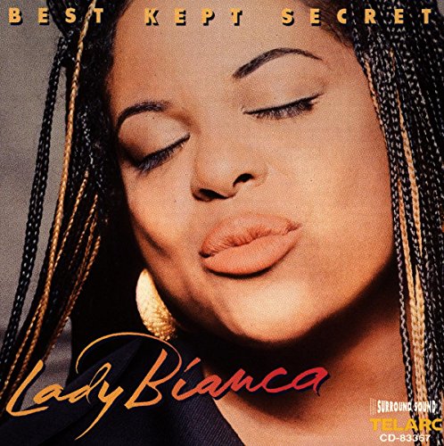 "Album cover featuring a woman with braids and closed eyes, titled 'Best Kept Secret'."