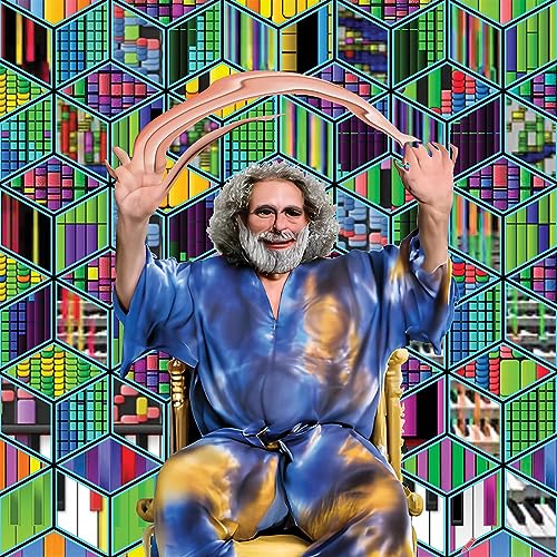 Man with beard in blue suit, geometric colorful background.