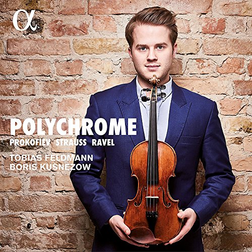 Man in blue suit holding violin against a brick wall, classical music album cover.