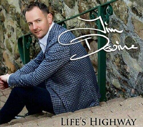 "CD cover featuring a man sitting on steps with a stone wall behind him."