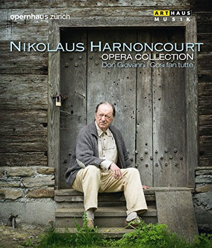 Man sitting on steps in front of a wooden door, opera collection cover art.