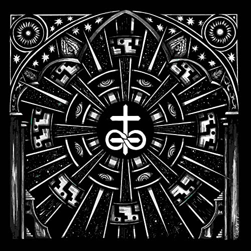 Black and white ornate circular design with eyes and a central symbol.