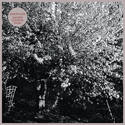 Black and white album cover with a tree and small garden gate.