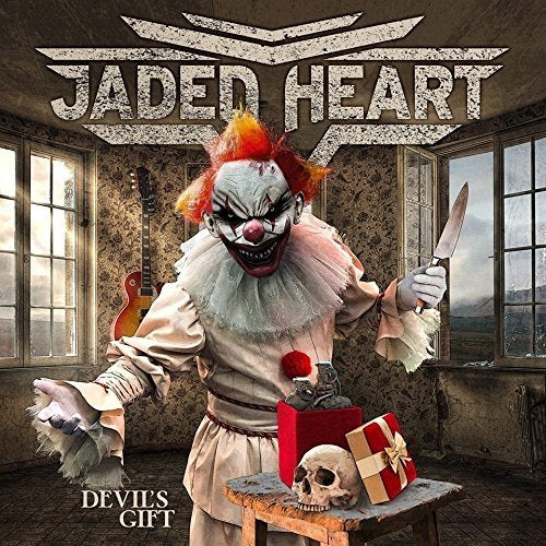 Creepy clown with knife, skull gift, and guitar; album cover art.