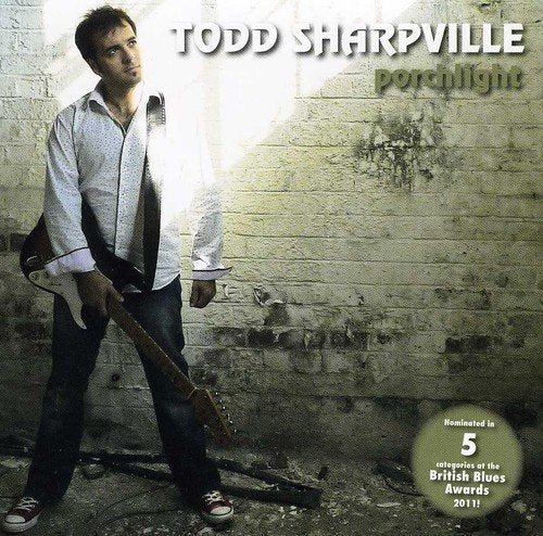 CD cover for Todd Sharpville’s “Porchlight” featuring the artist with a guitar.