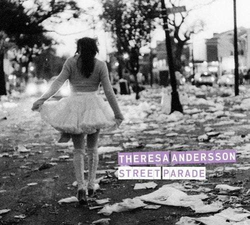 Black and white album cover with a woman walking away, text overlay.