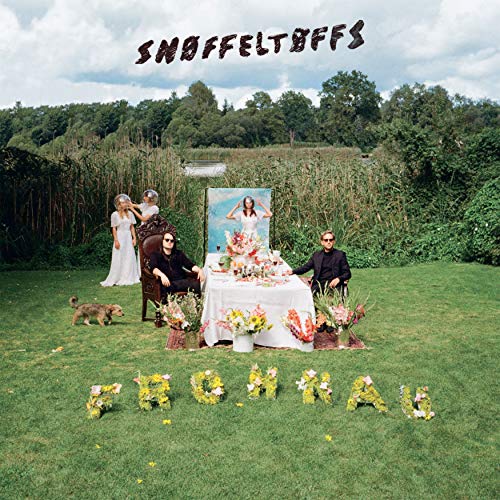 "Album cover with a group of people and dog in a grassy field."