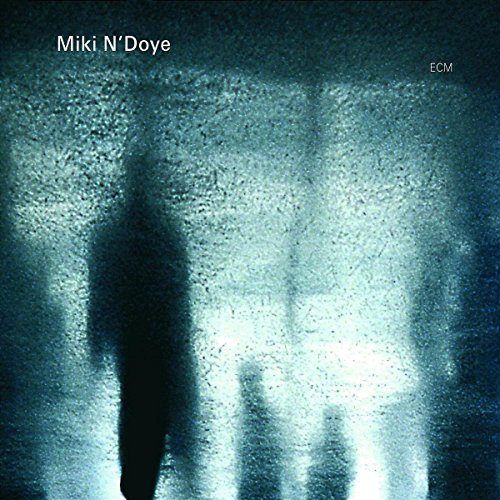 "CD cover with a shadowy figure and textured, blue-green background."