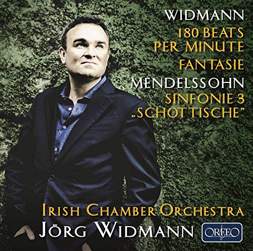 CD cover featuring a man in a suit against a green background.