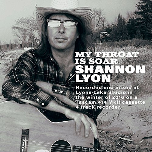 Black and white CD cover featuring musician Shannon Lyon with guitar.