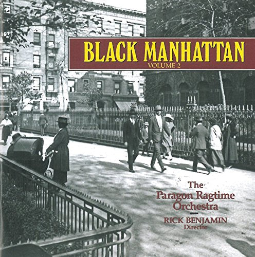 "Album cover featuring a black-and-white street scene with men walking."