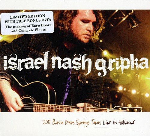 "Album cover featuring a man playing guitar on stage with stage lights in the background."