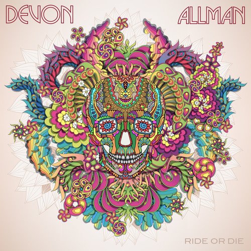 "Album cover with colorful sugar skull surrounded by floral patterns, on a beige background."