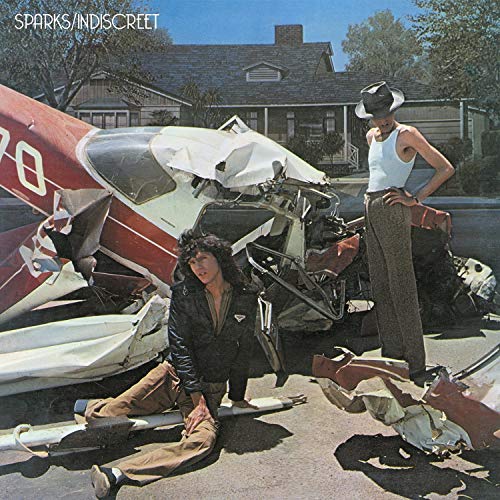 Sparks album cover: two people amidst the wreckage of a small plane.