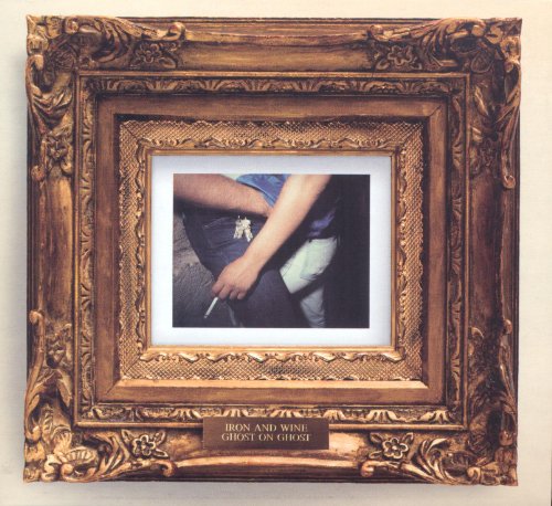 CD cover in ornate gold frame, showing a person’s waist and hands.