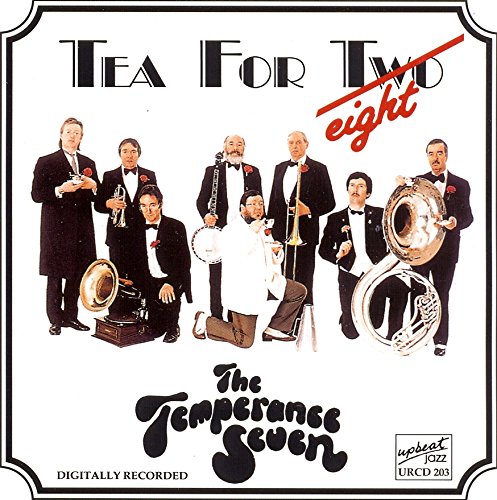 "CD cover with seven men in suits holding musical instruments, white background, black border."