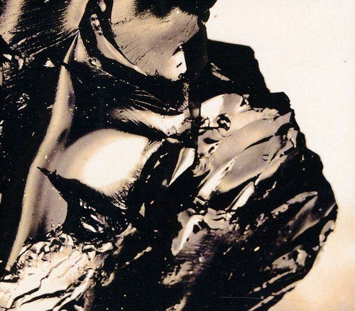 The image shows an abstract black and white design, possibly an album cover.
