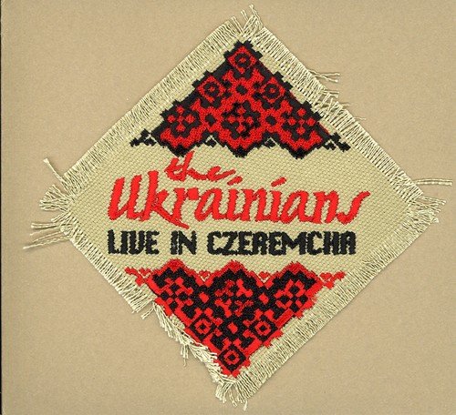 A beige embroidered patch with red and black designs and text on a brown background.