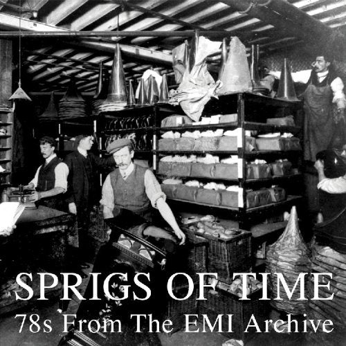 Black and white photo of men working in a factory with shelves of gramophone horns.