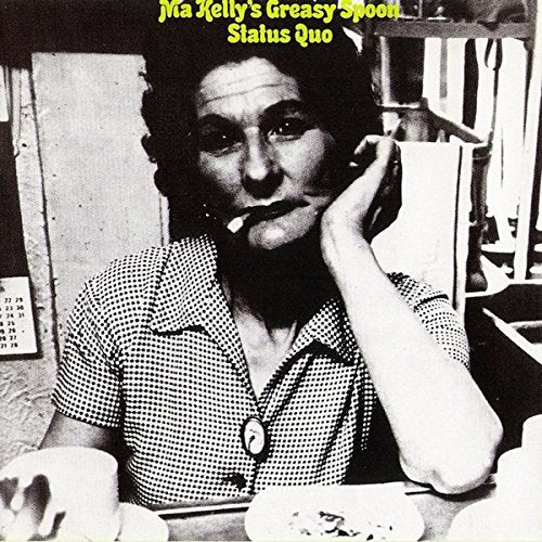 "Black and white vinyl album cover with a woman sitting at a table."