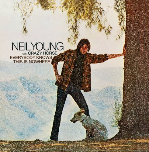 "Album cover featuring Neil Young and a horse by a tree."