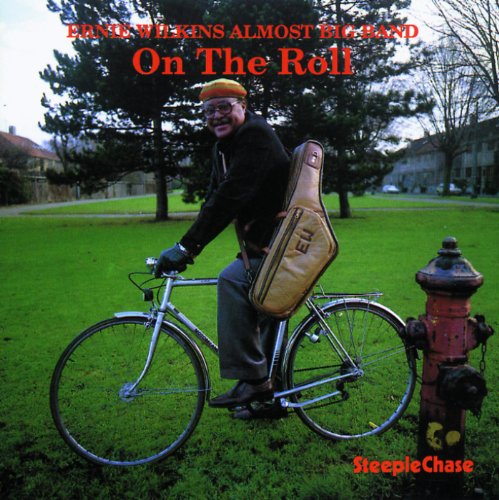 Album cover: man on bicycle with saxophone case, in a park, with red text overlay.