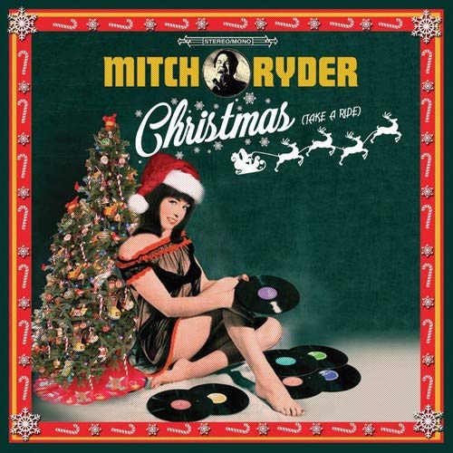 "Album cover featuring a woman in a Santa hat sitting with vinyl records and a Christmas tree."