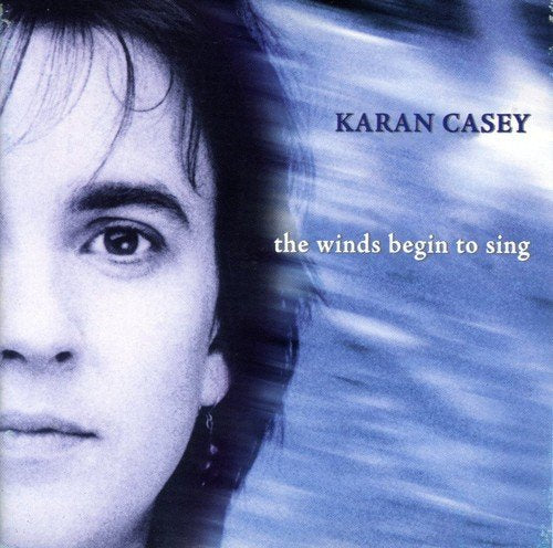 Album cover featuring a close-up of a woman's face with blurred blue background.