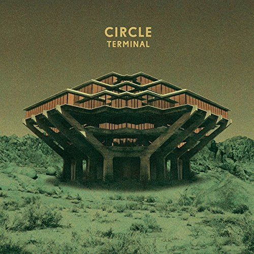 The alt text for the image is: "Vinyl album cover with futuristic building in a green landscape."