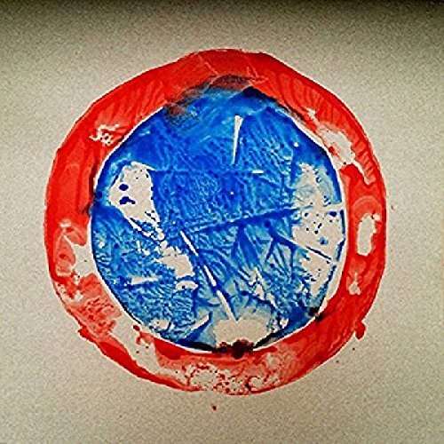 A CD with a blue center and red outer ring on a beige background.
