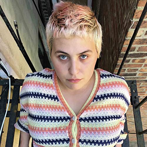 Close-up portrait of Lily Konigsberg with short, pink-tinted hair.