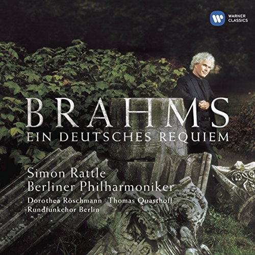 CD cover with conductor Simon Rattle standing among stone tombstones and greenery.