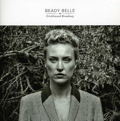 "Album cover featuring a black and white photo of a woman in a checkered jacket."