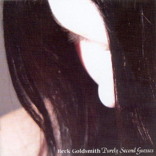 A woman's face is partially obscured by her long dark hair.