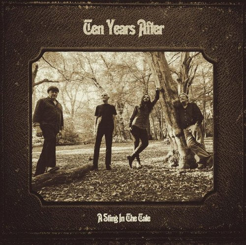 "Sepia-toned album cover with four men in a forest, dark textured background."