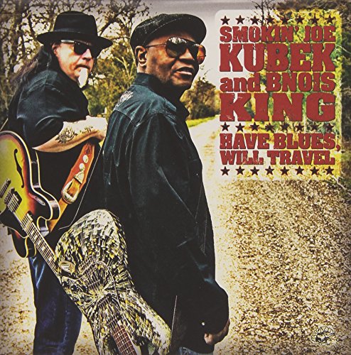 CD album cover featuring two men in black, one holding a guitar, outdoors.