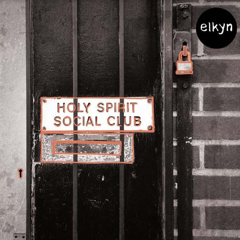 Black and white photo of a door with a sign reading “Holy Spirit Social Club.”