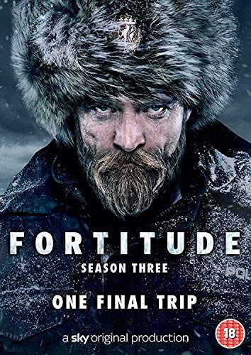 Close-up of a bearded man wearing a fur hat in a snowy environment.