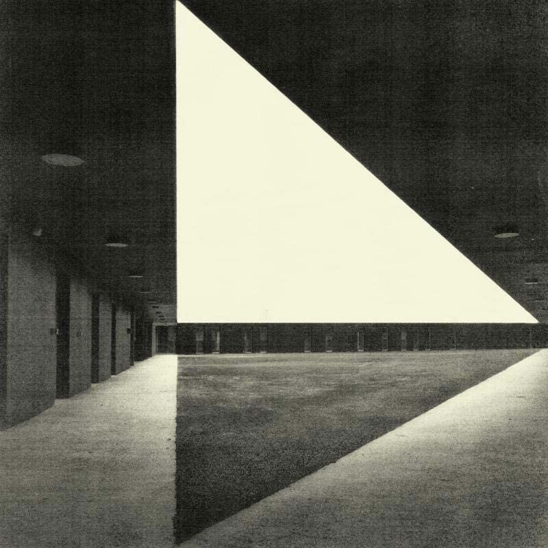 Black and white architectural photo featuring large triangular shapes and shadows.