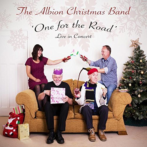"CD cover featuring four people on a couch, toasting, beside a Christmas tree."