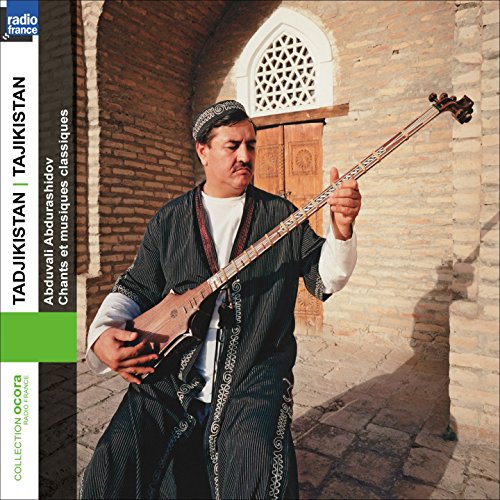 Man playing a long-necked stringed instrument in front of an arched doorway.