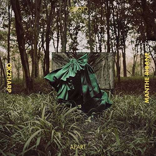 Album cover featuring a draped green figure in a forest setting.