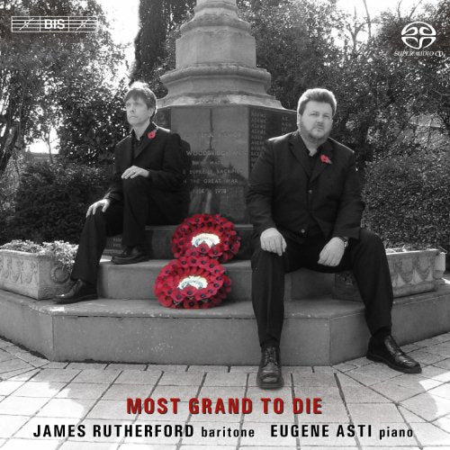 "Album cover with two men in black suits sitting by a war memorial."