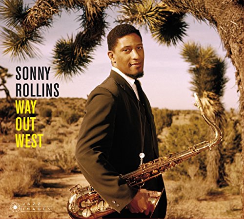 Album cover: man in suit holding saxophone, standing by a desert tree.