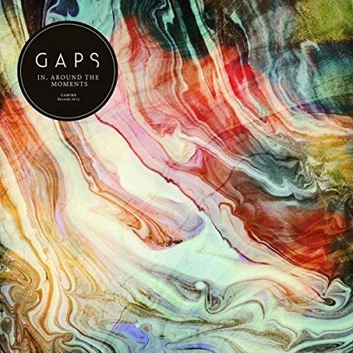 "Multicolored marbled vinyl record cover with 'GAPS' and 'In, Around The Moments' text."