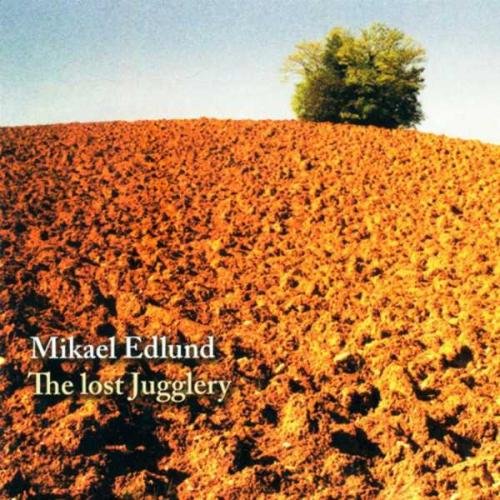"CD cover featuring a plowed field with a single tree in the background."
