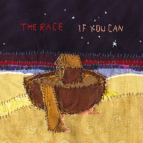 A CD cover with a person sitting in a bowl on a sandy surface.