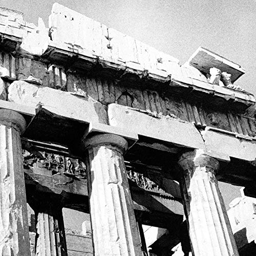 Black and white photo of crumbling classical architectural ruins.